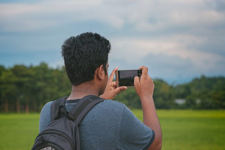 Person using a smartphone camera outdoors